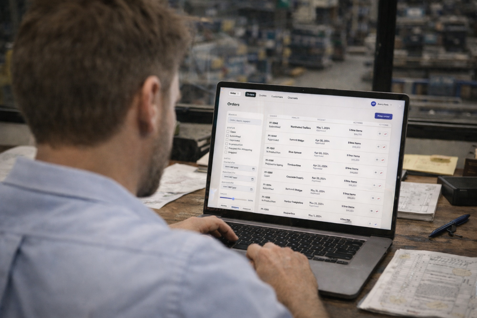 Order management screen displayed on a laptop in a workshop.